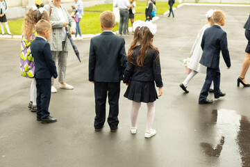 Fototapeta premium Schoolboy on street. First graders in school yard.