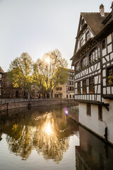Fototapeta na wymiar Traditional old alsatian houses at sunset from Pont st. Martin on a canal in Petit Venice (Small Venice) in Stasbourg in Alsace in the department of Haut-Rhin of the Grand Est region of France