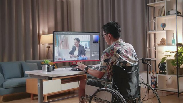 Back View Of Asian Man In Wheelchair In Photo Editing App, Software On His Personal Computer. Photo Editor Retouching Photos
