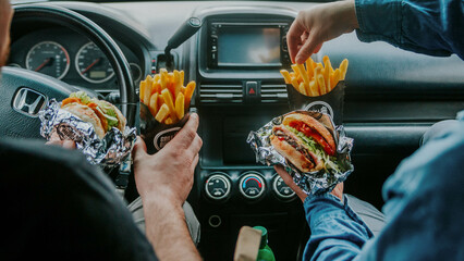 burger hands in a car