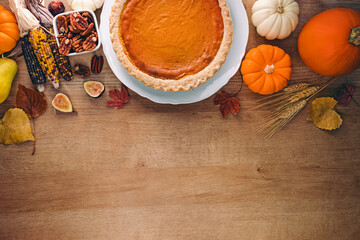 Thanksgiving flat lay. Pumpkin pie, autumn harvest on the wooden table, top view