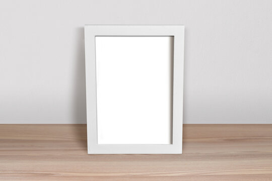 White Frame Mockup Leaning in Minimalist Room Scene