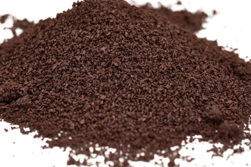 closeup of coffee grounds isolated on white 