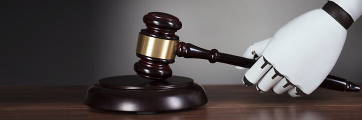 Robot's Hand Hitting Gavel At Desk