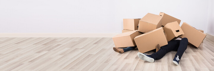 Couple Lying Under The Cardboard Boxes