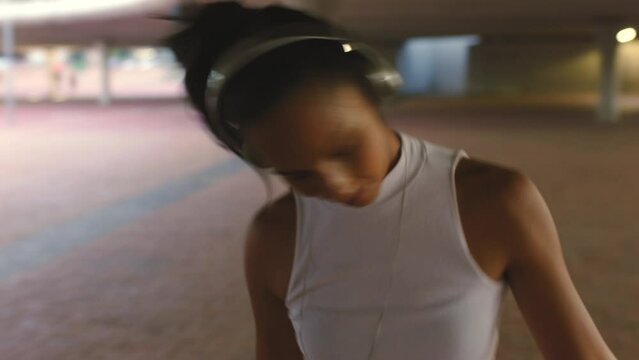 Hip hop, city woman and dance to headphones music on road or street in New York. Smile, happy and fun fashion dancer in creative energy movement, trippy grunge art or breakdance motion to radio audio