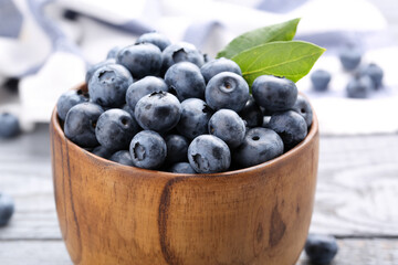 Tasty fresh blueberries on wooden table, closeup