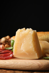 Snack platter with parmesan cheese served on wooden table, closeup