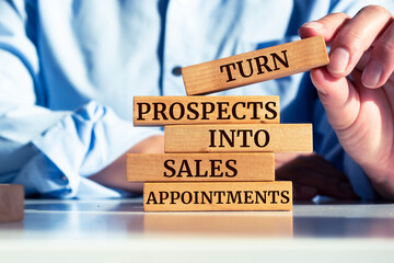 Wooden blocks with words 'Turn Prospects Into Sales Appointments'.