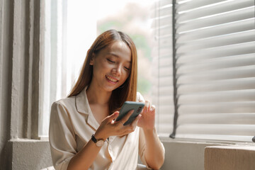 Young happy pretty asian woman using mobile smartphone for shopping online, cashless society concept.