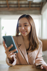 Young happy pretty asian woman using mobile smartphone for shopping online, cashless society concept.