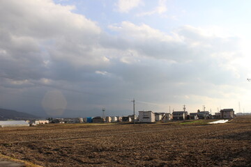 Fototapeta na wymiar 2013 view of growing town neighborhood and rice fields