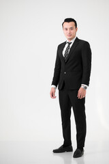 Obraz na płótnie Canvas Young Asian handsome, wearing a black suit and celebrating victory isolated on white background.