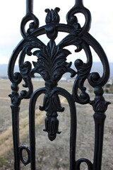 Ornate fencing looking over cut rice fields