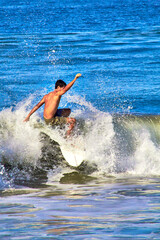 man surfing a wave , vertical picture in zicatela, puerto escondido oaxaca