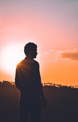 Man standing silhouette photo during sunset looking away