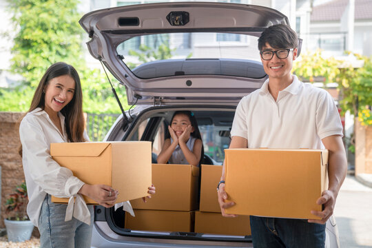 Asian family move to new house by a car