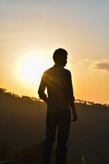 Man standing silhouette photo during sunset looking away