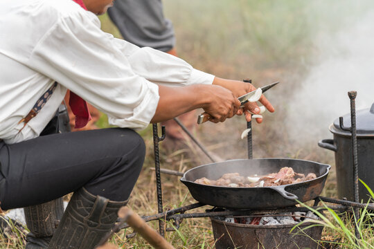 cowboy cooking food at camping