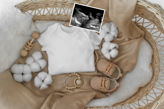 Mockup of white baby bodysuit shirt with basket, Social Media Pregnancy Announcement .Background with blurred . Selective focus