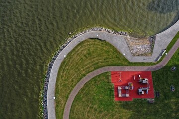 Playground and sports field by the sea lagoon, aerial view - 532875957