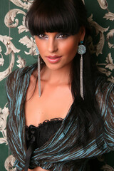 Portrait of a beautiful fashion girl brunette in the studioin a jacket and underwear retro 90s...