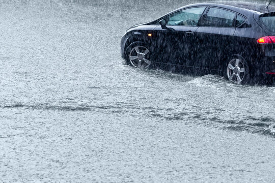 car rides on big water in the rain. driving in stormy weather.