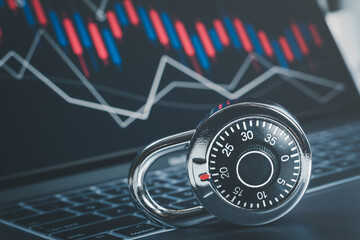 Combination padlock on stock market chart background, financial security concept.