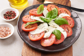 Fresh Italian salad antipasto called caprese with buffalo mozzarella, sliced tomatoes and basil with olive oil. Ingredients for vegetarian caprese salad. Italian food. top view. Rustic style.