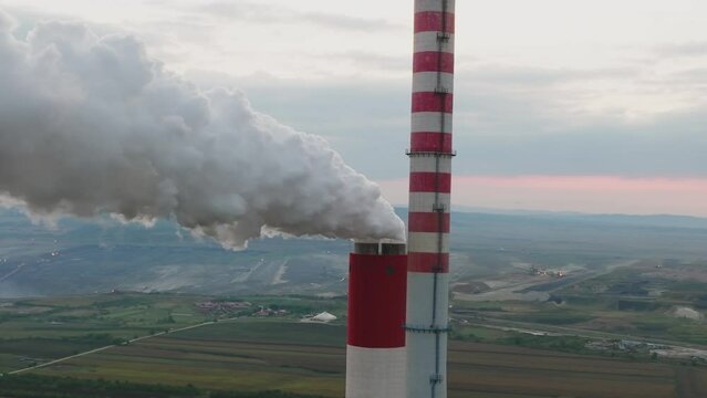 Aerial rone shot of industrial plant emitting toxic vapor to nature. Ecology and environmental pollution problem