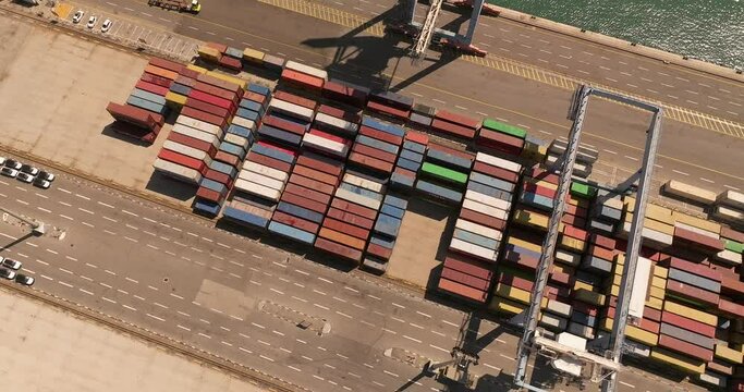 Port dock with Shipping Containers, transtainer cranes, new cars and Container ship. 
