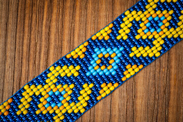 Chokers made of braided beads of blue-yellow color with Ukrainian folk patterns.