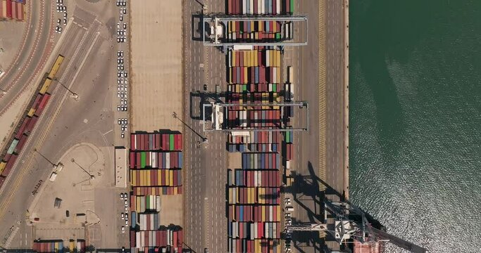 Port dock with Shipping Containers, transtainer cranes, new cars and Container ship. 
