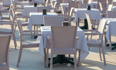 Tables and chairs in an open-air cafe.
