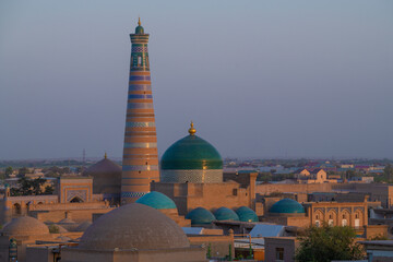 Islam Khoja Minaret in the evening cityscape. Khiva, Uzbekistan