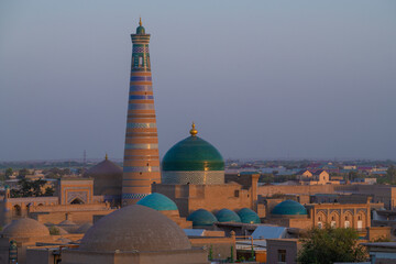 Naklejka premium Islam Khoja Minaret in the evening cityscape. Khiva, Uzbekistan