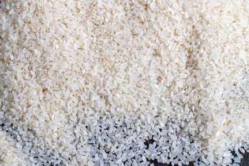 a pile of scattered white rice on the kitchen table