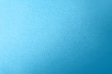 Soft dark cyan blue color gradation with light tone on corrugated fiberboard blank paper texture...