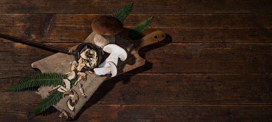 Dark food photography background - Fresh and dried forest mushrooms / Boletus edulis (king bolete)...