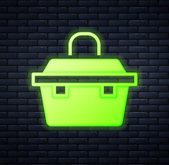 Glowing neon Case or box container for wobbler and gear fishing equipment icon isolated on brick wall background. Fishing tackle. Vector