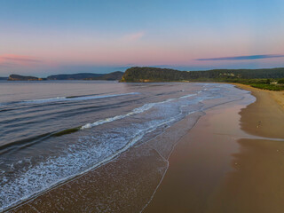 Gentle sunrise seascape with light scattered high cloud
