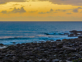 Drizzly moody sunrise seascape with cloud filled sky