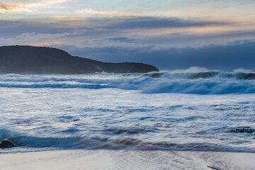 Cloud covered sunrise sesacape in soft pastel shades