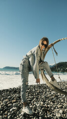 Girl with one foot stands on a swing bent over