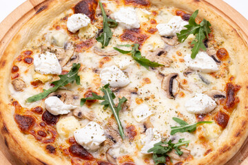 Delicious Italian pizza with champignons, cheese, arugula.