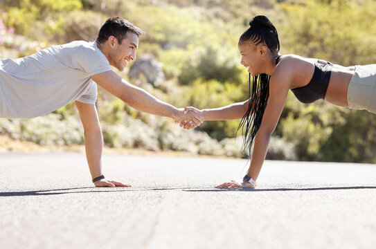 Motivation, fitness and handshake by exercise partnership deal with athletic couple shaking hands in workout challenge outdoors. Friends, hands and pushup fun with sports, bonding and competitive