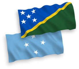 National vector fabric wave flags of Federated States of Micronesia and Solomon Islands isolated on white background. 1 to 2 proportion.