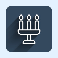 White line Candelabrum with three candlesticks icon isolated with long shadow background. Blue square button. Vector