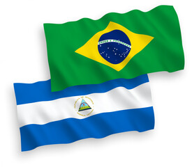 National vector fabric wave flags of Brazil and Nicaragua isolated on white background. 1 to 2 proportion.