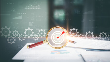 A magnifying glass is placed on the table showing a graph of business growth, formulating corporate...